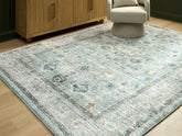 Luxury Living Gallery - Ashley Furniture - Ladstoney Rug - 7'6" x 9'6" Area Rug / Teal/Beige/Ochre - R407501