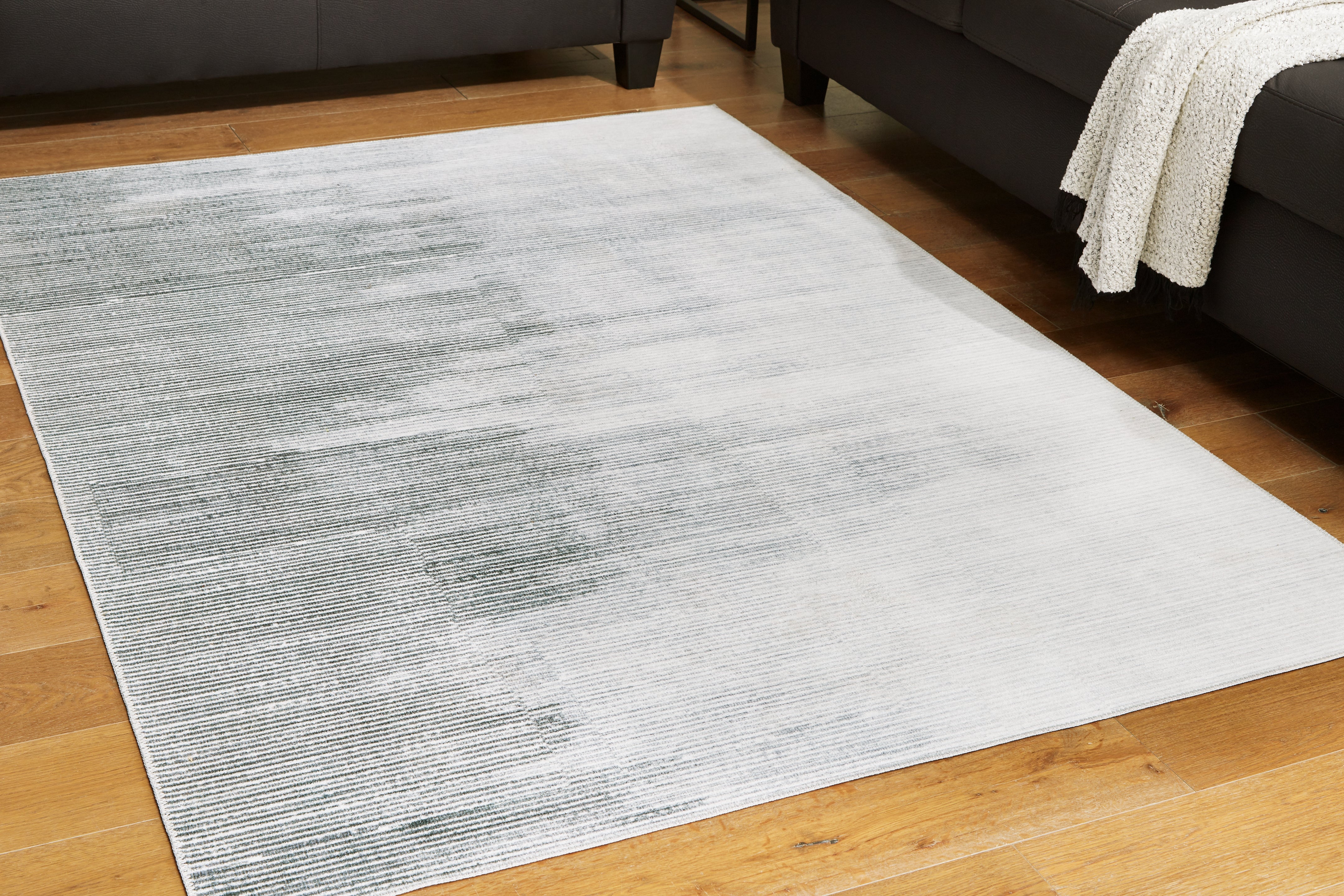 Luxury Living Gallery - Ashley Furniture - Milset Rug - 8'1" x 10' Washable Rug / Black/White/Gray - R406251